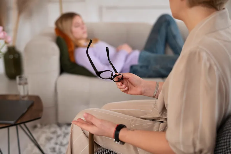 Young girl talking therapist side view