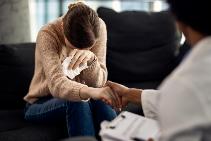 depressed woman seeking solace in her psychotherapist