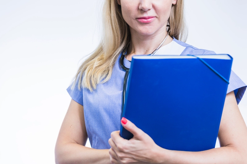 Close up female dentist with folder